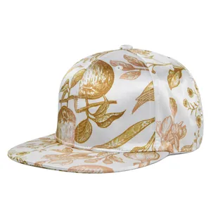Detail of white and gold satin flat brim baseball cap with vintage floral embroidery