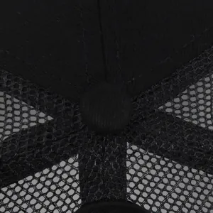 Vue macro du bouton supérieur et des panneaux en maille noire respirante de la casquette