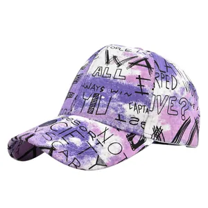 Detail of purple tie-dye baseball cap with black graffiti letters and curved brim