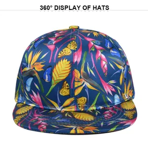 Detail view of tropical print baseball cap with vibrant floral patterns and smooth satin texture