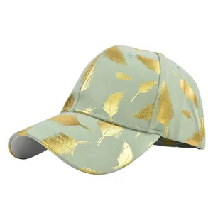 Sage green baseball cap featuring gold foil feather patterns and a curved brim design