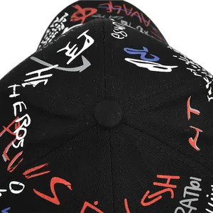 Top view detail of black canvas baseball cap featuring colorful graffiti embroidery and button