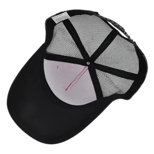 Detail of black mesh trucker hat interior showing 50% cotton and polyester blend label