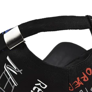 Close-up of black baseball cap with metallic adjustable buckle and street style graffiti print