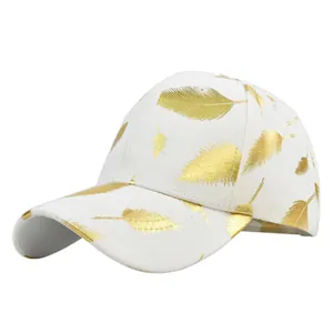 Detailed side view of white baseball cap with shiny gold feather print patterns