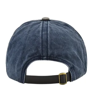 Detail view of washed blue baseball cap with adjustable metal buckle and strap on the back