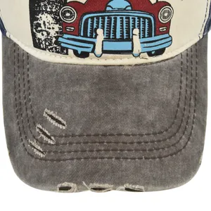 Detail of vintage American baseball cap featuring distressed brim and retro car print