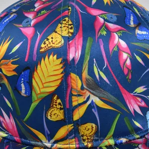 Detail of Route 66 embroidered baseball cap with vibrant tropical butterfly prints
