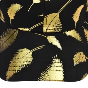 Detailed close-up of golden feather print and stitching on a black baseball cap