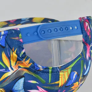 Close-up of blue floral baseball cap with butterfly print and adjustable snapback strap