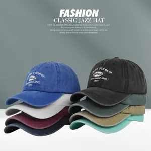 Detailed pile of vintage washed cotton baseball caps with classic embroidery text