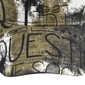 Detailed macro view of distressed canvas fabric and QUEST graffiti print on baseball cap