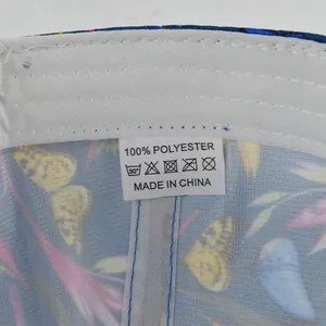Close-up of baseball cap interior showing 100% polyester label and floral lining
