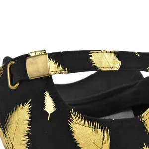 Detail of adjustable gold metal buckle and feather embroidery on black baseball cap
