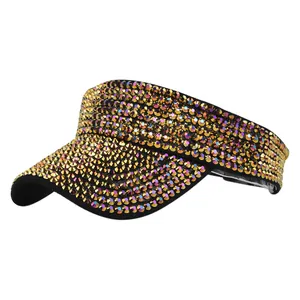 Detailed view of shimmering gold rhinestones on a black sun visor hat for outdoor sun protection