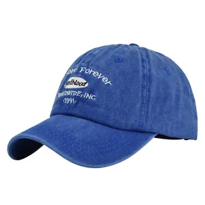 Close-up of vintage washed blue cotton baseball cap featuring detailed white embroidery