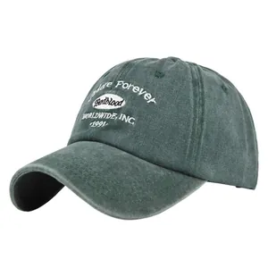 Close-up of vintage dark green baseball cap with white embroidery on washed cotton fabric