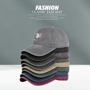 Close-up of stacked vintage washed cotton baseball caps with eagle embroidery detail