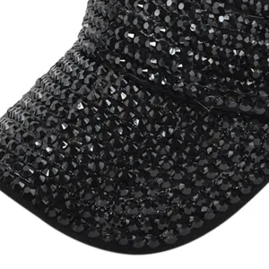 Detailed macro view of high-quality black rhinestones on a breathable baseball cap surface