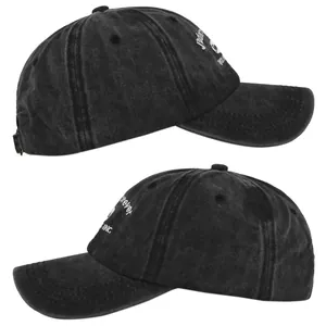Side view of washed black denim baseball cap with white embroidery detail and stitching