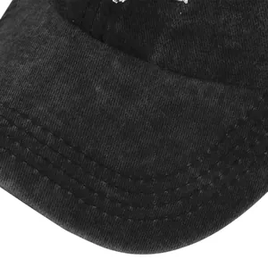 Detailed macro view of vintage washed black cotton baseball cap with reinforced stitching
