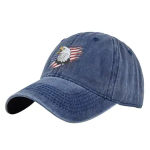 Detailed close-up of American eagle graphic and flag embroidery on blue denim cap