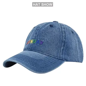 Close-up of colorful Sunday embroidery on blue denim fabric baseball cap