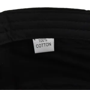 Close-up of internal care label on military cap showing 100% cotton fabric detail