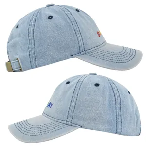 Detail of light blue washed denim baseball cap with colorful SUNDAY embroidery and metal buckle