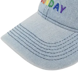 Close-up of light blue denim baseball cap featuring colorful Sunday rainbow embroidery