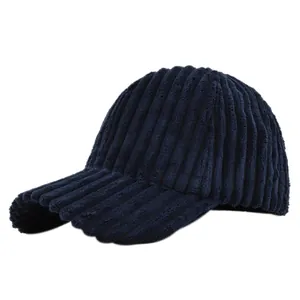 Detailed close-up showing the soft corduroy texture of the navy blue baseball cap