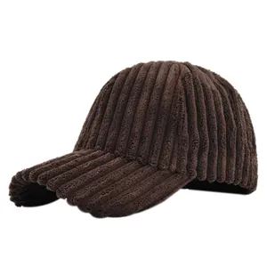 Detailed view of the dark brown corduroy texture and curved brim on a baseball cap