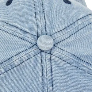 Macro detail of light blue denim baseball cap top with dark contrast stitching