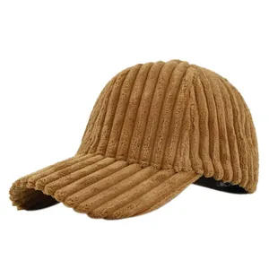 Close-up of thick corduroy texture on a warm brown winter baseball cap with curved brim