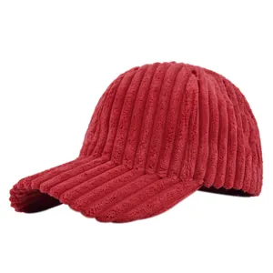 Detailed macro view showing the thick corduroy texture and stitching of the red baseball cap