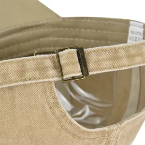 Detailed view of khaki cotton baseball cap with adjustable strap and brass metal buckle