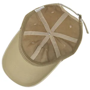 Macro view of khaki cotton baseball cap interior showing stitching and care label