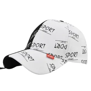 Detail of SPORT print and red woven label on side of black and white baseball cap