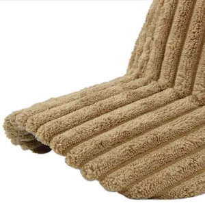 Detailed macro view of the thick corduroy texture and stitching on the camel baseball cap