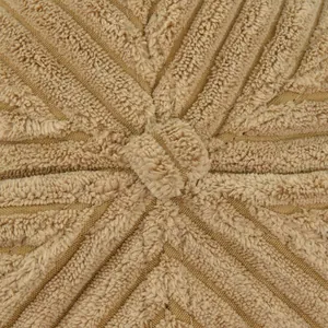 Macro shot of khaki corduroy cushion featuring radial stitching and a center fabric button