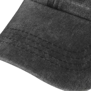 Macro detail of washed gray baseball cap showing stitching and cotton twill fabric texture