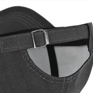Detail of adjustable metal buckle and stitching on dark gray cotton baseball cap