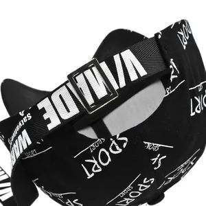 Detail of adjustable strap and buckle on a black baseball cap with white sport print