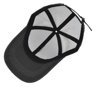 Close-up of baseball cap interior showing white lining, black straps and metal buckle