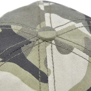 Macro detail of camouflage mesh baseball cap top button and reinforced stitching