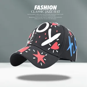 Detail of black graffiti baseball cap with white JOY letters and colorful street art patterns