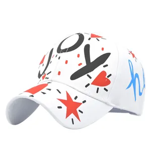 Detailed view of colorful graffiti prints and JOY text on white baseball cap