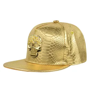 Golden hip hop baseball cap with snakeskin texture and metallic skull badge detail