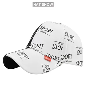 Detail view of white cotton baseball cap with black sport print and red woven tag