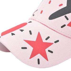 Detail of pink cotton baseball cap featuring red star print and clean stitching